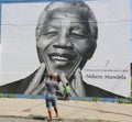 Unidentified family taken picture in the front of Nelson Mandela mural in Williamsburg section in Brooklyn