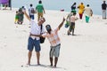 Unidentified family woman man child and caucasian man taking a walk at beautiful sunny morning at Danushkodi beach. Pilgrims from