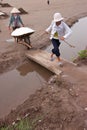 An unidentified farmers are harvesting salt