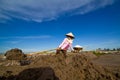 An unidentified farmers are harvesting salt