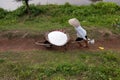 An unidentified farmers are harvesting salt