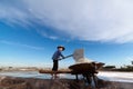 An unidentified farmers are harvesting salt