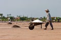 An unidentified farmers are harvesting salt