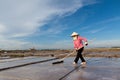 An unidentified farmers are harvesting salt