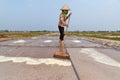 An unidentified farmers are harvesting salt