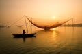 Unidentified fisherman checks his nets in early morning on river in Hoian, Vietnam Royalty Free Stock Photo