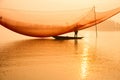 Unidentified fisherman checks his nets in early morning on river in Hoian, Vietnam Royalty Free Stock Photo