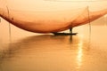 Unidentified fisherman checks his nets in early morning on river in Hoian, Vietnam Royalty Free Stock Photo