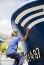 Fisherman painting his boat in Puerto de Mogan, Gran Canaria