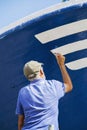 Fisherman painting his boat in Puerto de Mogan, Gran Canaria