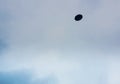 Unidentified flying object against the cloudy sky.