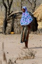 Unidentified Fulani woman stands in the bational clothes in the Royalty Free Stock Photo