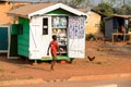 Unidentified Ghanaian boy passes by the stall in local village.