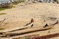 Unidentified Ghanaian people rest on canoes on the coast of Elm