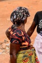 Unidentified Ghanaian woman from behind in colored clothes in E