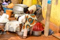 Unidentified Ghanaian woman bend down to pick something up from