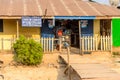 Unidentified Ghanaian woman buys something in the shop in local