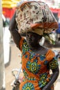 Unidentified Ghanaian woman carries a bag on her head at the Ku