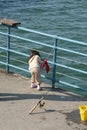 Girl fishing on a pier