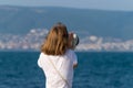 An unidentified girl looking through a tower viewer at sea in Nessebar, Bulgaria. A girl looking through a coin binocular, free Royalty Free Stock Photo