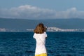 An unidentified girl looking through a tower viewer at sea in Nessebar, Bulgaria. A girl looking through a coin binocular, free Royalty Free Stock Photo