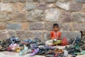 An unidentified girl watches foot wear of hindu devotees