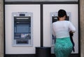 Unidentified girl withdrawing money from an ATM machine