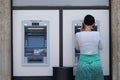 Unidentified girl withdrawing money from an ATM machine