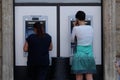 Unidentified girl withdrawing money from an ATM machine