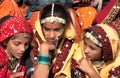 An unidentified girls in colorful ethnic attire attends at the