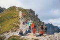 Unidentified group of hikers resting and exhausted at Krzyzne Pass in High Tatra Mountai