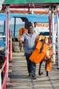 Documentary editorial. RAMESWARAM, RAMESHWARAM, TAMIL NADU, INDIA - March circa, 2018. Unidentified indian man hang Life jacketfor Royalty Free Stock Photo