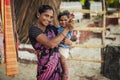 Unidentified Indian woman and baby in her arms are smiling with very