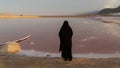 Unidentified Iranian woman in hijab burka near Maharloo pink lake, Shiraz, Iran
