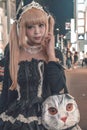 Japanese girl in black costume and blonde dived hair walking at Harajuku in Tokyo Japan example of typical Japanese