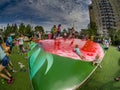 Unidentified joyful children are jumping fun on inflatable trampoline