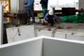 Labor man working on construction site with helmet pulling concrete slabs using pulley Royalty Free Stock Photo