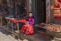 an unidentified little girl sitting that sells products of pottery in a stall on December 2, 2013 in Bhaktapur, Kathmandu