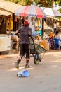 Unidentified local man pulls a cart in a village in Guinea Biss