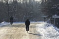 Unidentified locals men ride bicycles on the winter road