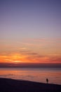 Man walking on the beach at sunset Royalty Free Stock Photo