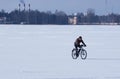 Unidentified male cyclist riding a bike in the winter