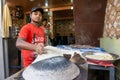 Unidentified Man baking an chapati roti at Chandni Chowk