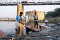 Unidentified man doing a laundry at Dhobi Ghat is a well known open air laundromat in Yamuna River