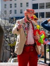 A unidentified man dressed clown amuse people