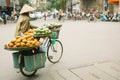 Unidentified man drives a bicycle with baskets in Hanoi, Vietnam. Street vending by bike is an essential part of life in Vietnam