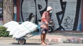 Unidentified man with a heavily loaded handcart