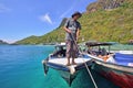 Unidentified man pulling a passenger boat rope