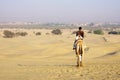 Unidentified man riding a camel in Thar desert