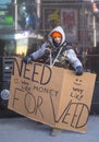 Unidentified man with sign asking for money to buy weed on Broadway during Super Bowl XLVIII week in Manhattan